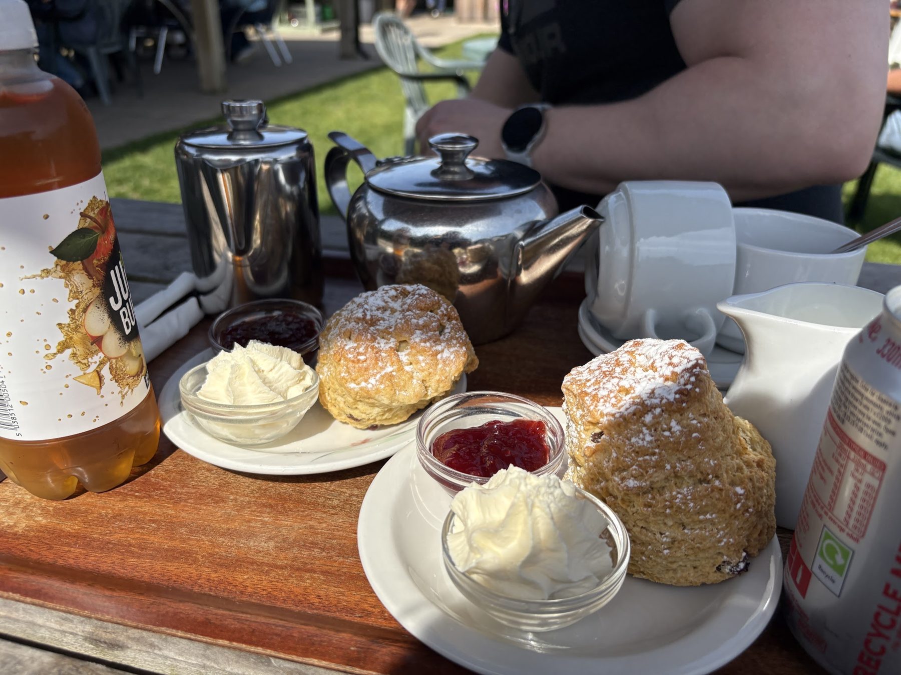 Scones with jam and cream, metal teapots